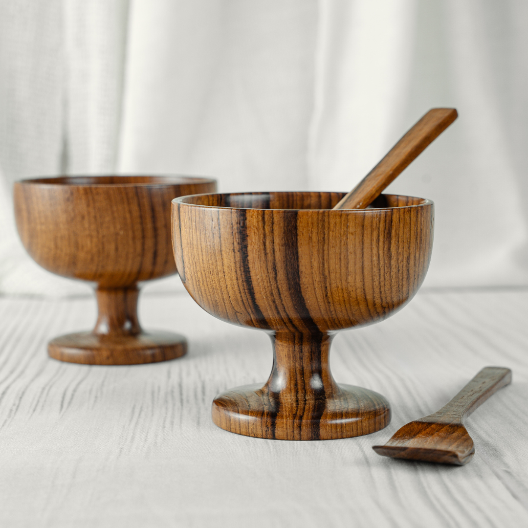 Two wooden ice cream bowls with a spoon