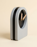 Modern clock with a minimalist design on a beige background